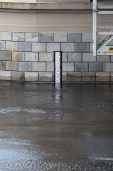 Black and white water level gauge on the bridge during the flood
