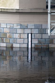 Black and white water level gauge on the bridge during the flood
