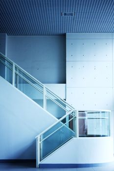 Modern interior of hall with stair with blue toned