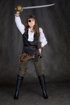 The girl - pirate with a sabre in hands and eye patch on face