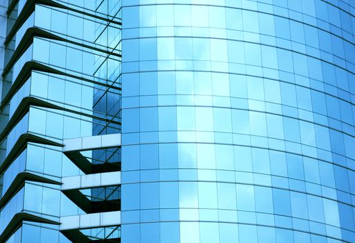 modern blue glass wall of skyscraper in city