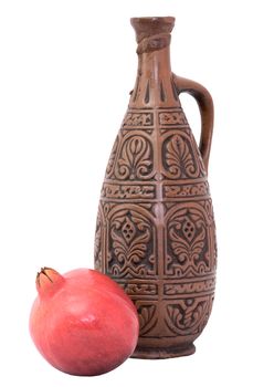 Still-life with a bottle and pomegranate on a white background