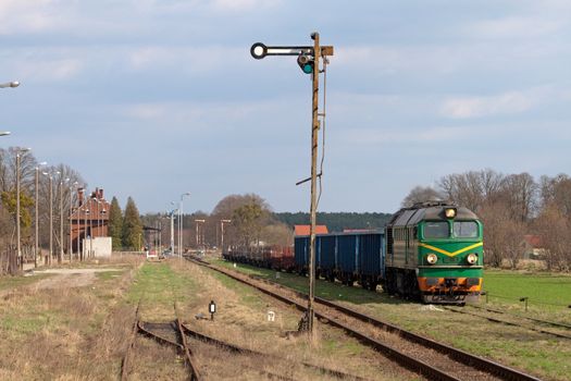 Freight train hauled by the diesel locomotive waiting at the station

