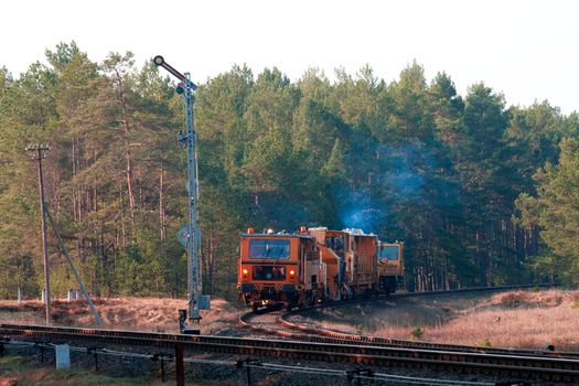 Railway heavy duty machines train entering the station
