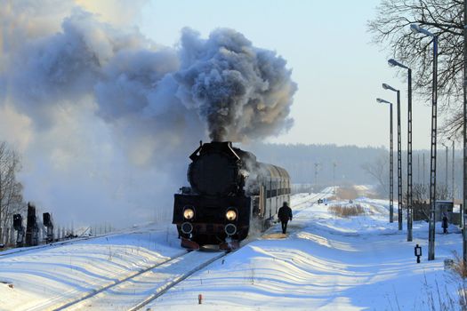 Vintage steam train stopped at the station, wintertime