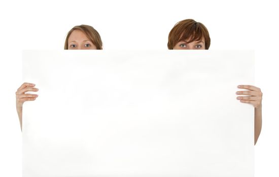 Two young women behind a blank banner ad, on white background.