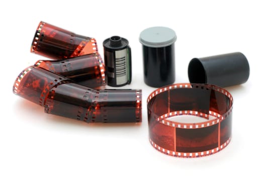 35 mm negative film and canisters isolated in white background