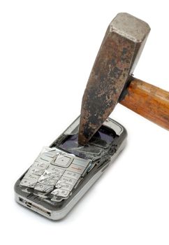 Hammer smashing cellular phone isolated on the white background