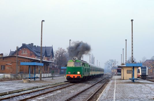 Locomotive is starting its engine on the station