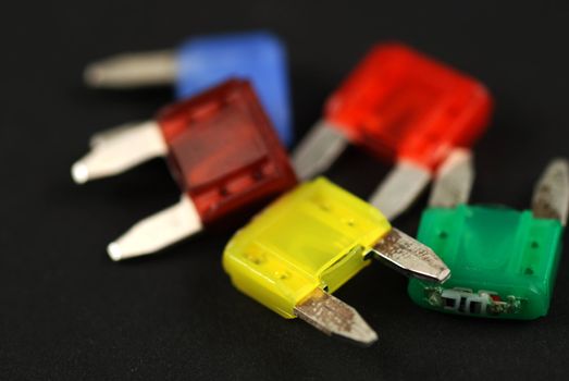 electrical automobile fuses with shallow depth of field on black background