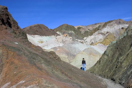Desert landscape with multicolored yellow, green purple and blue clay mineral deposits in geological formations of Death Valley National Park