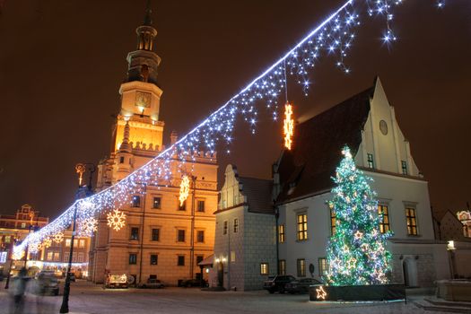 Old market square during the snowy night in poznan, poland