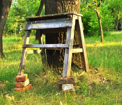 old bench on bricks is put to tree