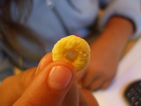 Person holding a small yellow cereal.