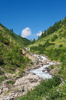 beautiful stream between rocks in Veny valley, Courmayeur. Italy