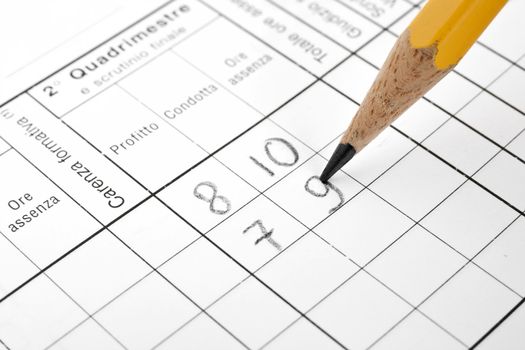 closeup of italian school report card with pencil