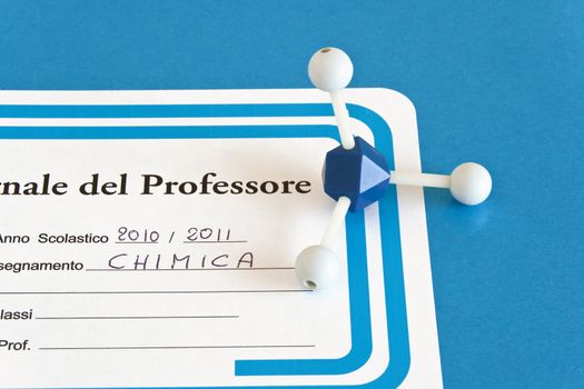 closeup of italian teacher's register with molecular model
