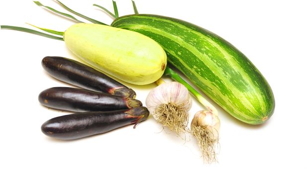 fresh vegetables from bed on white background