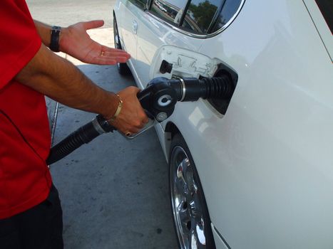 Close up of a person pumping gas.