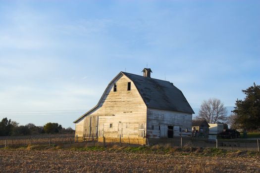 Fragment of farm barn with maize soy and wheat fields  