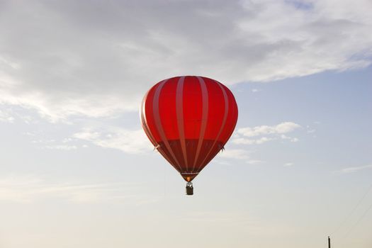 Red hot air balloon over farm fields near Omaha Nebraska