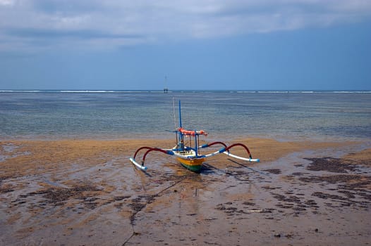 A fishing boat docked on the beach, Sanur, Bali, Indonesia.