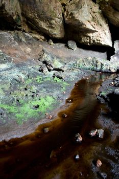 Mineral filled stream at the entrance to a cave system