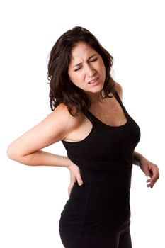 Beautiful woman holding her back with pain and ache due to injury,wearing a sporty black tank top, isolated.