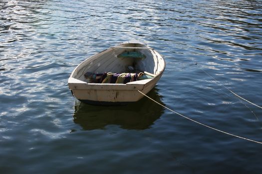 Rowboat drifting at anchor on the river