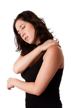 Beautiful woman holding her shoulder with neck pain and ache due to stress,wearing a sporty black tank top, isolated.