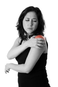 Beautiful woman holding her shoulder with pain and ache,wearing a sporty black tank top, isolated.