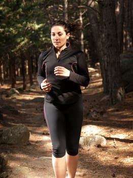 Young woman running on woods, outdoor background