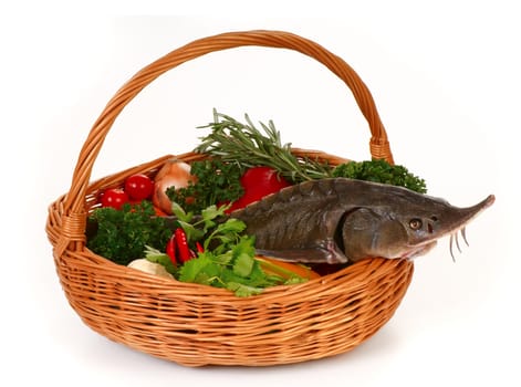 Still life. Basket with fresh vegetables and sturgeon. 