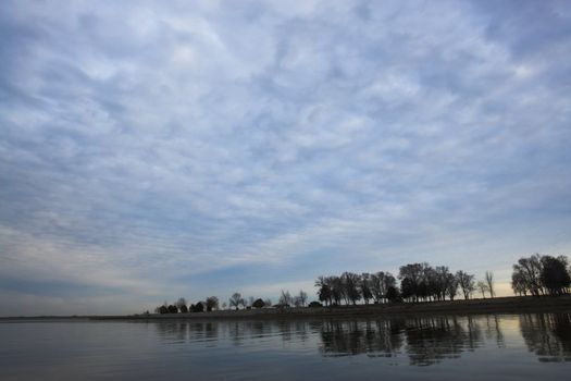 Trees reflection in the lake at sunset in Nebraska 