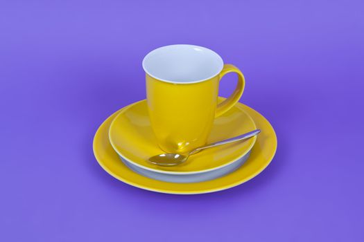 An image of a yellow coffee cup on purple background