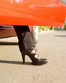 Woman leaves the red car