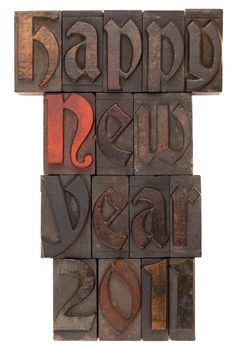 Happy New Year 2011 in antique wooden letterpress printing blocks (Abbey typeface) isolated on white