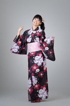 Happy smiling Japanese girl dancing in traditional clothing.
