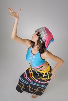 Dancing pose with Chinese traditional colorful dress, Dai nationality.