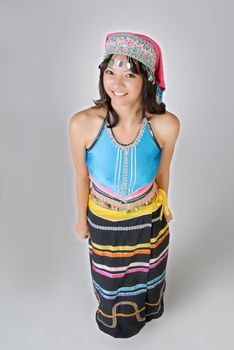 Chinese minority nationality girl, Dai, with smiling face and colorful dress.