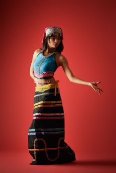 Mysterious dancer of Chinese girl in traditional colorful dress, Dai minority nationality.