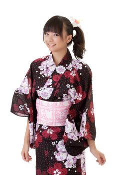 Young Japanese girl smiling in traditional clothes against white.