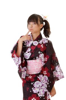 Adorable Japanese girl with funny expression in traditional clothes.