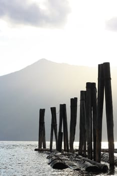 old poles in the water on sunset water reflection