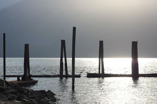 old poles in the water on sunset water reflection