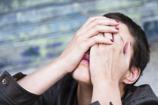 anguished young woman, her head tilted back, his face hidden in her hands