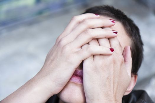 desperate young woman, her head tilted back, his face hidden in her hands