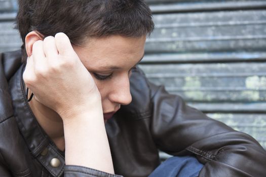 worried girl, her face pressed against her right hand