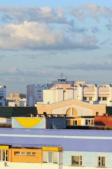 City roofs of houses in beams of the evening sun