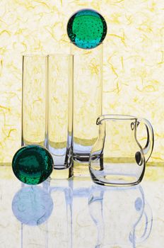 Glass glasses and jug on a yellow background